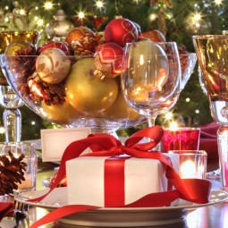 Elegant  holiday table setting with red ribboned gift