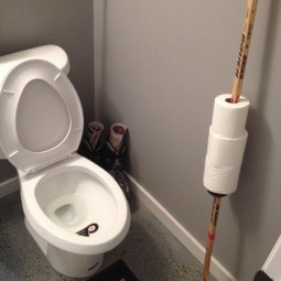 A toilet paper holder made out of hockey sticks.jpg
