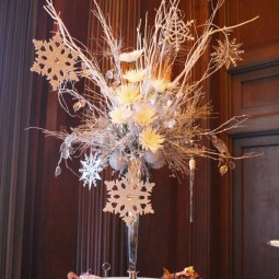 Winter table setting with tall vase fillwed with branches flowers and hanging snowflakes.jpg