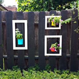 Add a pop of color to your fence using old picture frames and up cycled cans as planters.jpg