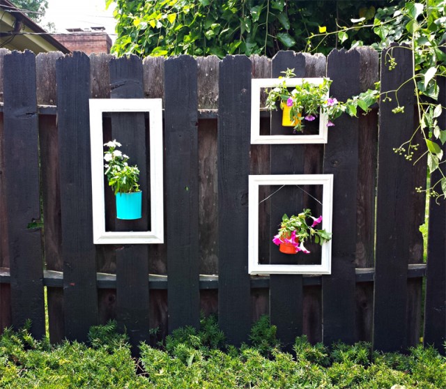 Add a pop of color to your fence using old picture frames and up cycled cans as planters.jpg