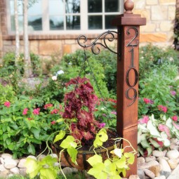 Attach numbers to a wooden post and hang a basket of flowers.jpg