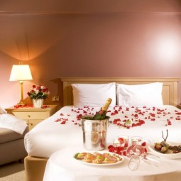 Bedroom decoration for valentines day with flowers and champagne.jpg