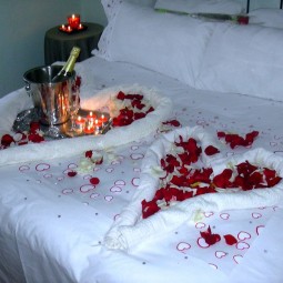 Bedroom decoration for valentines day with hearts made from towels and rose petals 10.jpg
