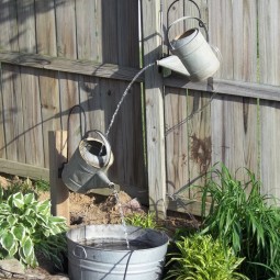 Create a small water feature using your old watering cans and pails.jpg