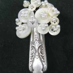 Make a beautiful brooch from silverware and buttons.jpg
