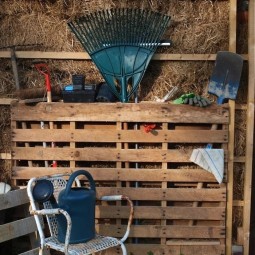 Use a recycled wooden pallet to corral garden tools.jpg