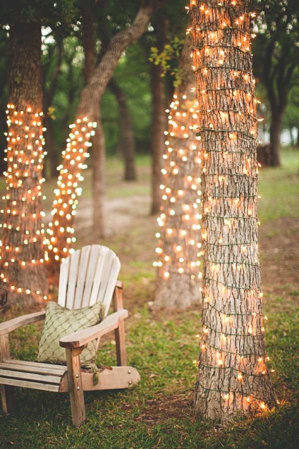 Wrap a few trees in white rope lights to create gorgeous sitting area.jpg