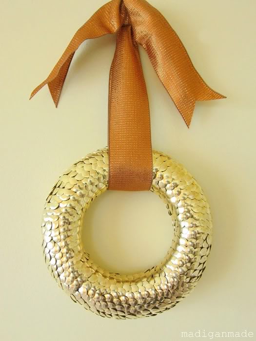Use brass thumbtacks to create a golden and textured wreath.jpg