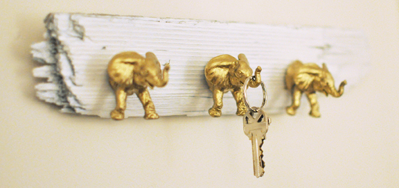Use plastic toys gold spray paint and driftwood to make these cute key hooks.jpg