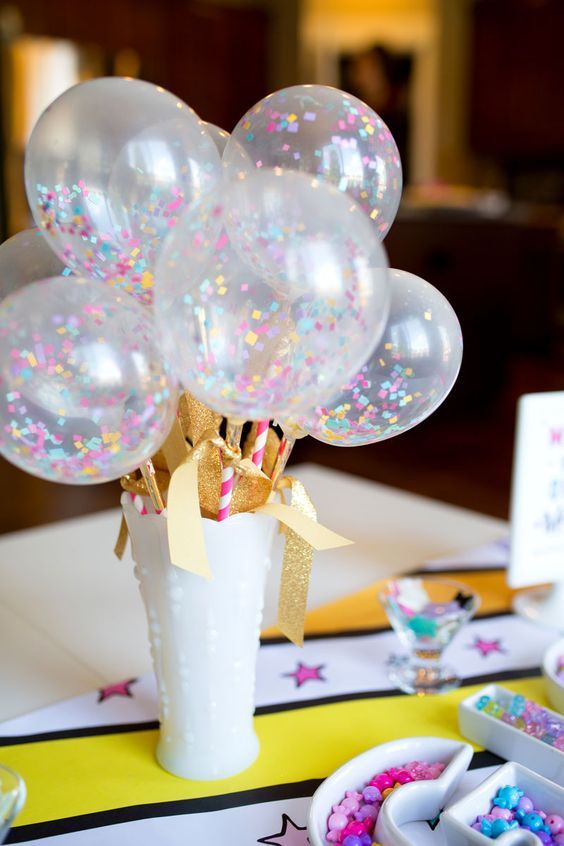 03 a white vase with glitter gold paper and sheer balloons with colorful confetti inside.jpg