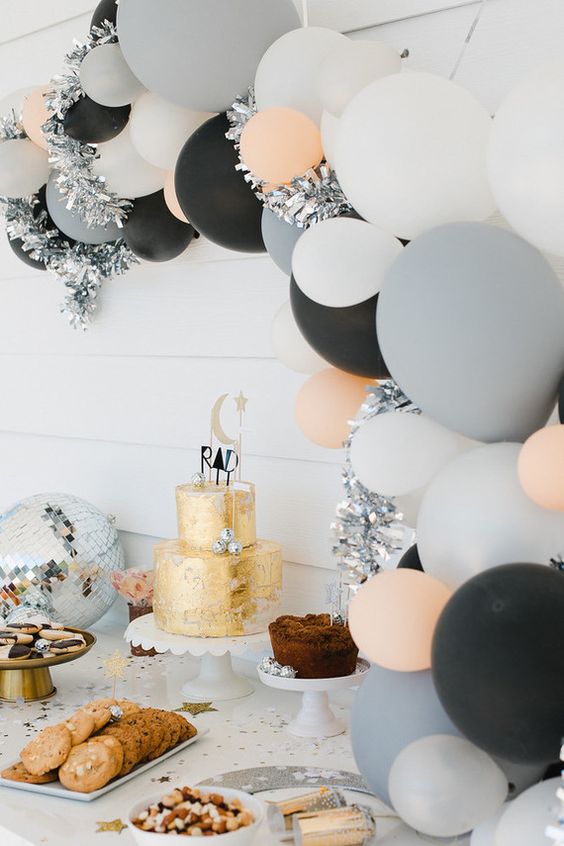 14 cool modern balloon arch over the dessert table.jpg