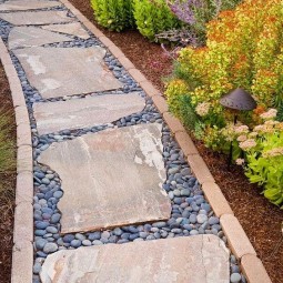 A pathway lined in brick with stepping stones and pebble filler | Outdoor Areas
