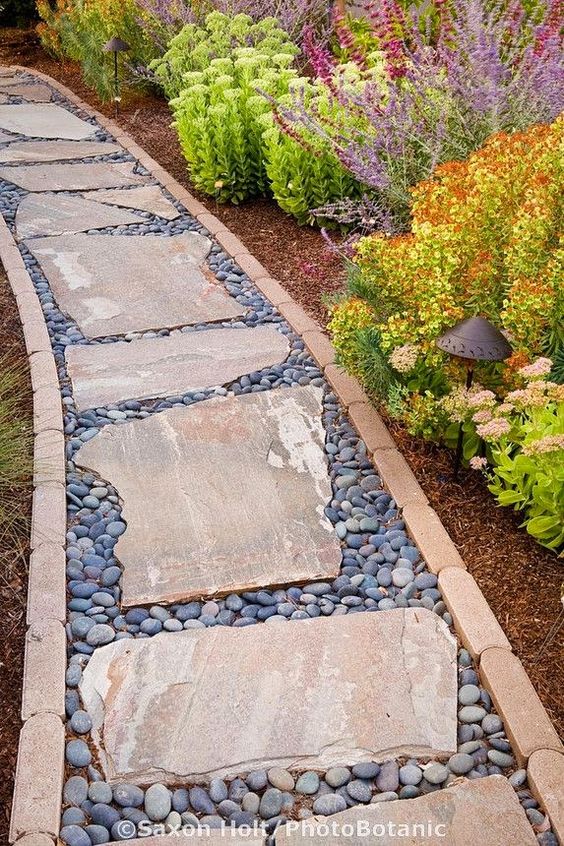 A pathway lined in brick with stepping stones and pebble filler | Outdoor Areas