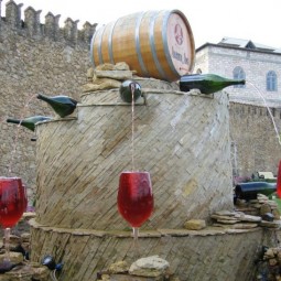 Simple yet unique diy water garden fountain by utilizing barrel and wine bottles also glasses 728x546.jpg