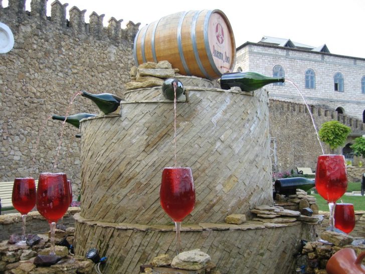Simple yet unique diy water garden fountain by utilizing barrel and wine bottles also glasses 728x546.jpg