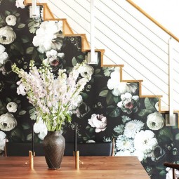 11 a side of the stairs covered with moody floral wallpaper in dark greens and neutrals.jpg