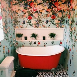 18 colorful floral wallpaper for a bathroom and a red bathtub that echoes with the walls.jpg