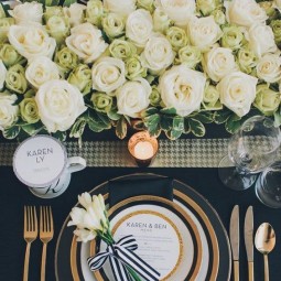 Black white and gold place setting for a wedding reception.jpg
