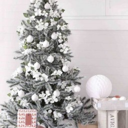 All white floral ornaments on snowy christmas tree.jpg