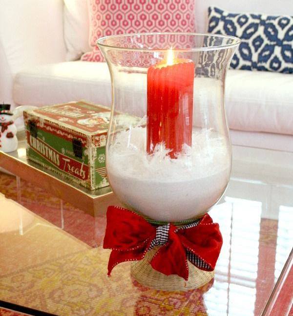 Rocking red candle with white sand in glass hurricane.jpg