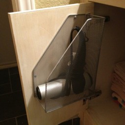 Save countertop space by attaching a magazine holder to the inside of your bathroom cabinet doors.jpg
