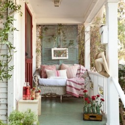 Vintage inspired compact front porch with a seeting area and wine colored front door.jpg