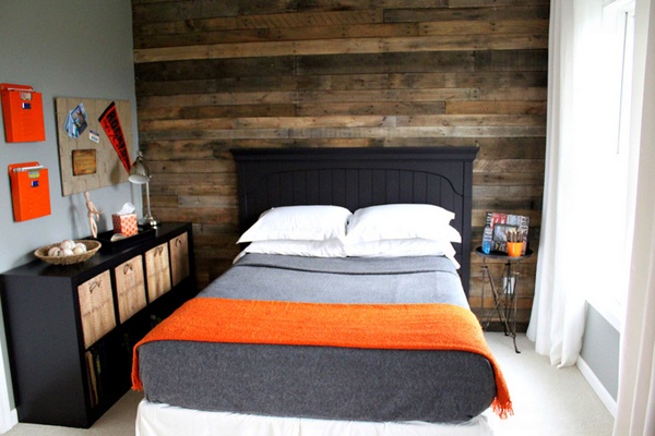 Small bedroom with masculine decor idea present hardwood accent wall and compact black storage furniture.jpg