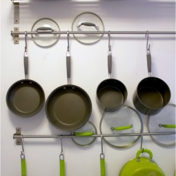 Small kitchen hacks rods with hooks for extra pan and lid storage.jpg