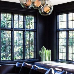 14 dark hued room with purple accents cact and unique pendants.jpg
