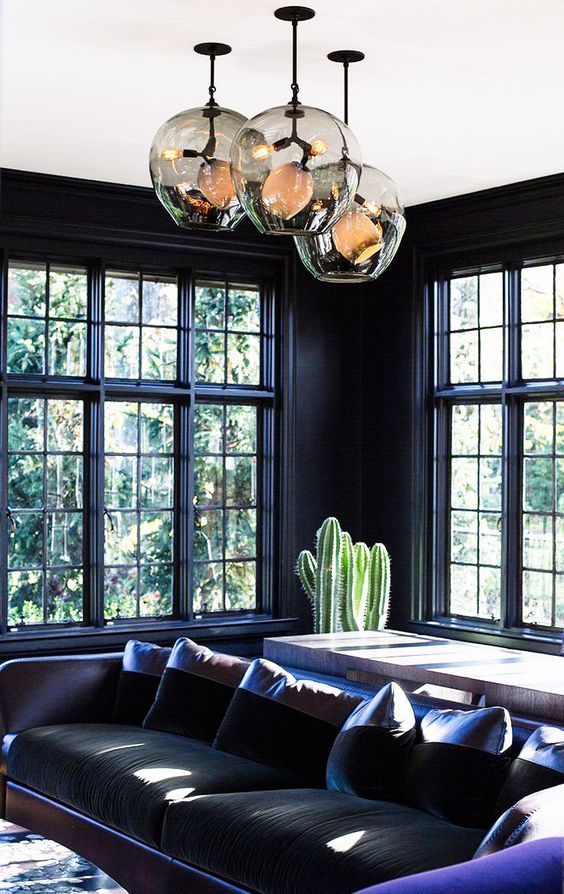 14 dark hued room with purple accents cact and unique pendants.jpg