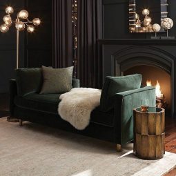 16 soft black living room with a dark green sofa art deco lights and a working fireplace.jpg