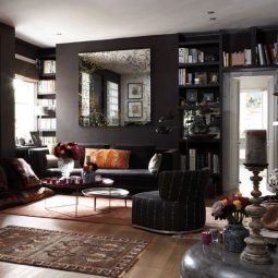 22 dark living room with black walls colorful accessories and various textiles.jpg
