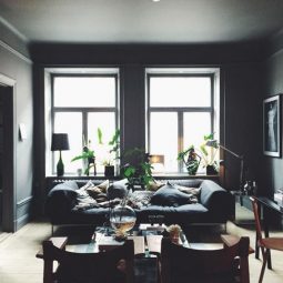 29 moody living room in dark grey and black flooded with light and enlivened with greenery.jpg