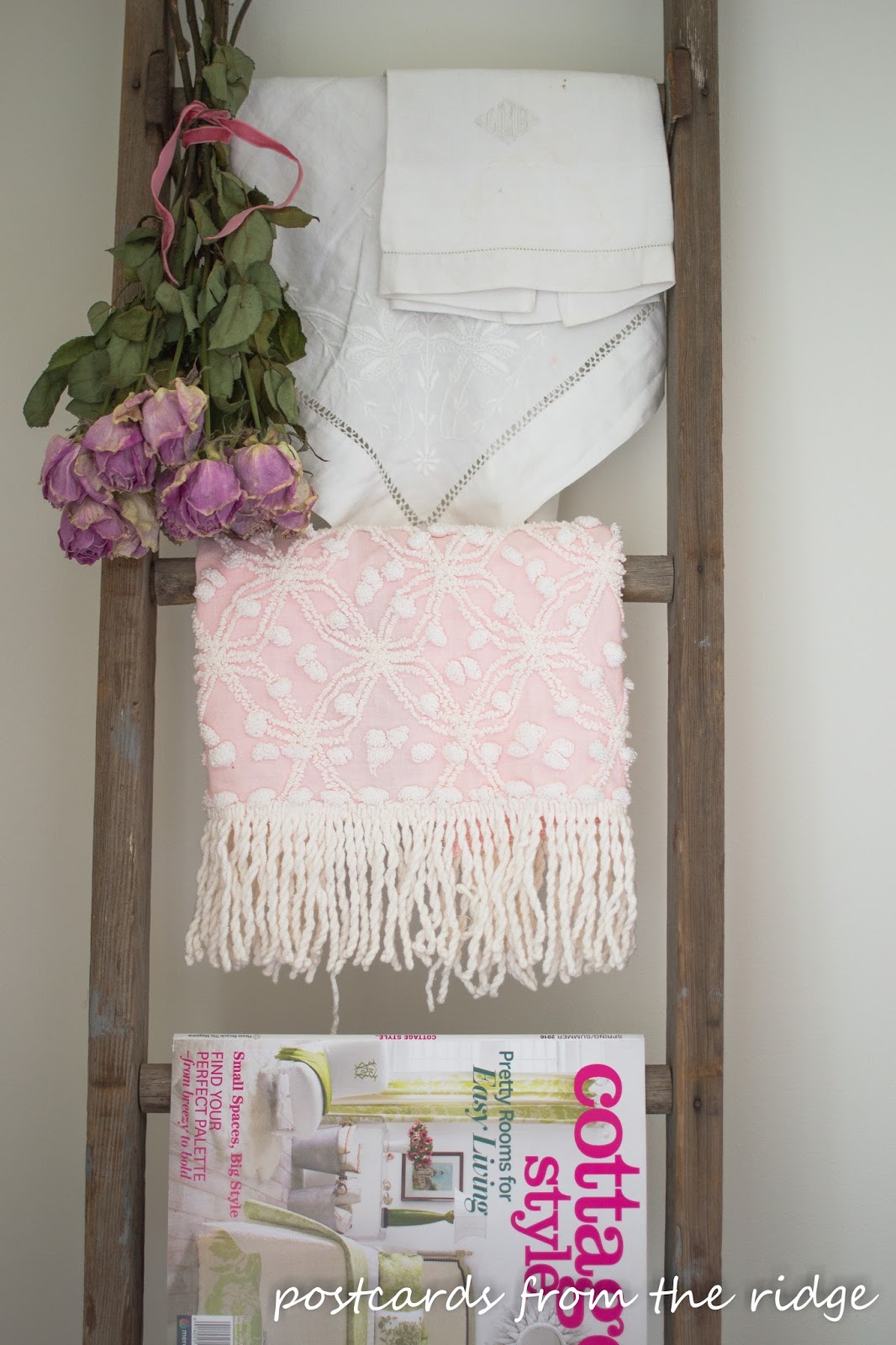 Dried roses and vintage linens on an old ladder.jpg