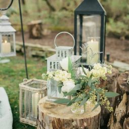 Simple floral and lantern tree stump wedding decor.jpg